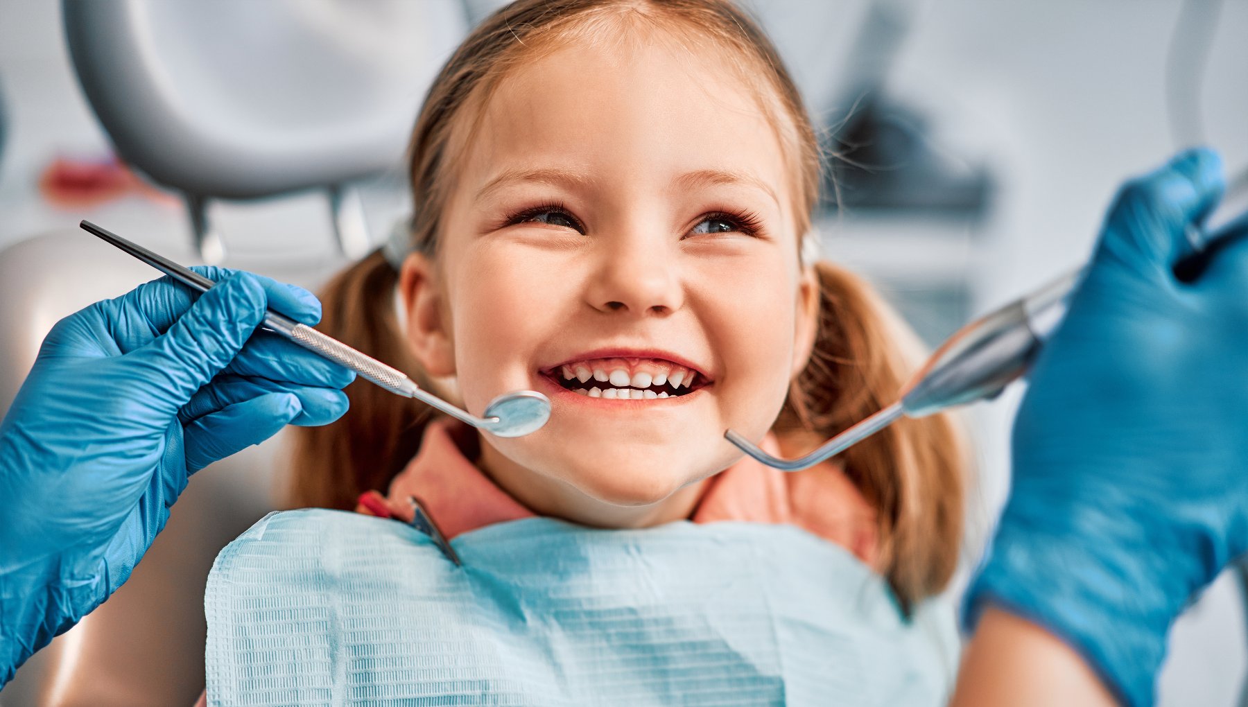 Smiling young girl at a pediatric dental checkup in Greenville, MS